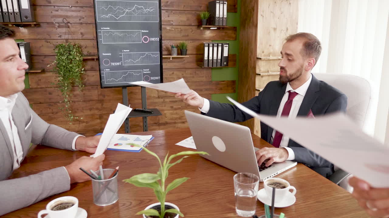 Businessman in suit working on laptop in the conference room