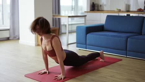 Woman-in-sportswear-doing-cow-cat-pose,-exercises-on-mat