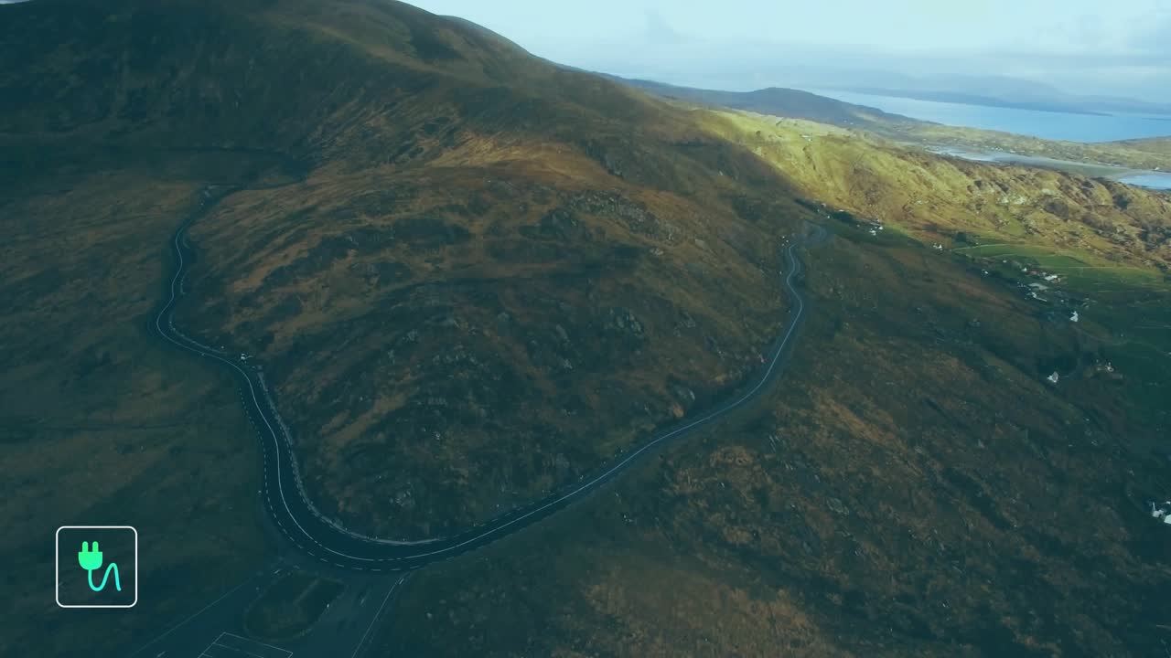 After aerial view holding steady, icons popping up along hillside road to highlight green growth