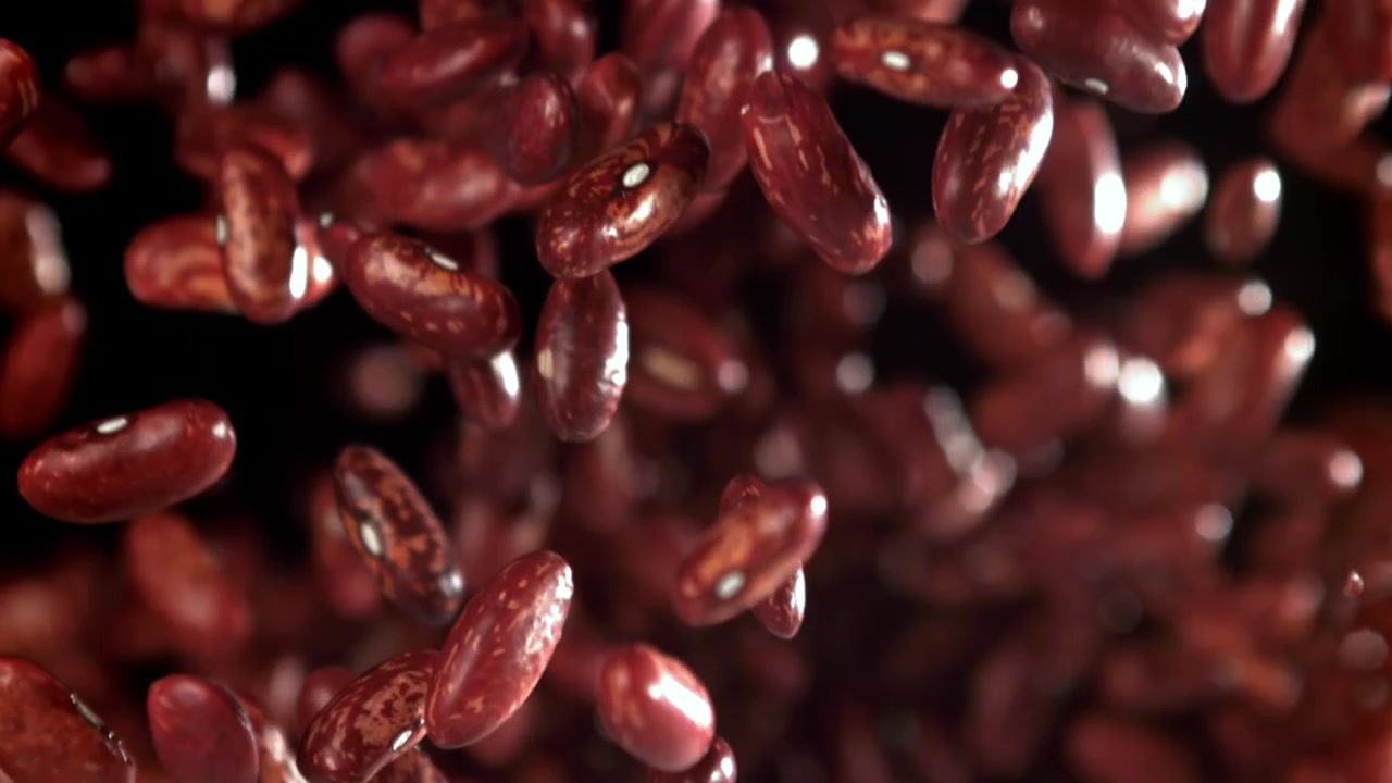 Red Kidney Beans Falling in Super Slow Motion on Black Background