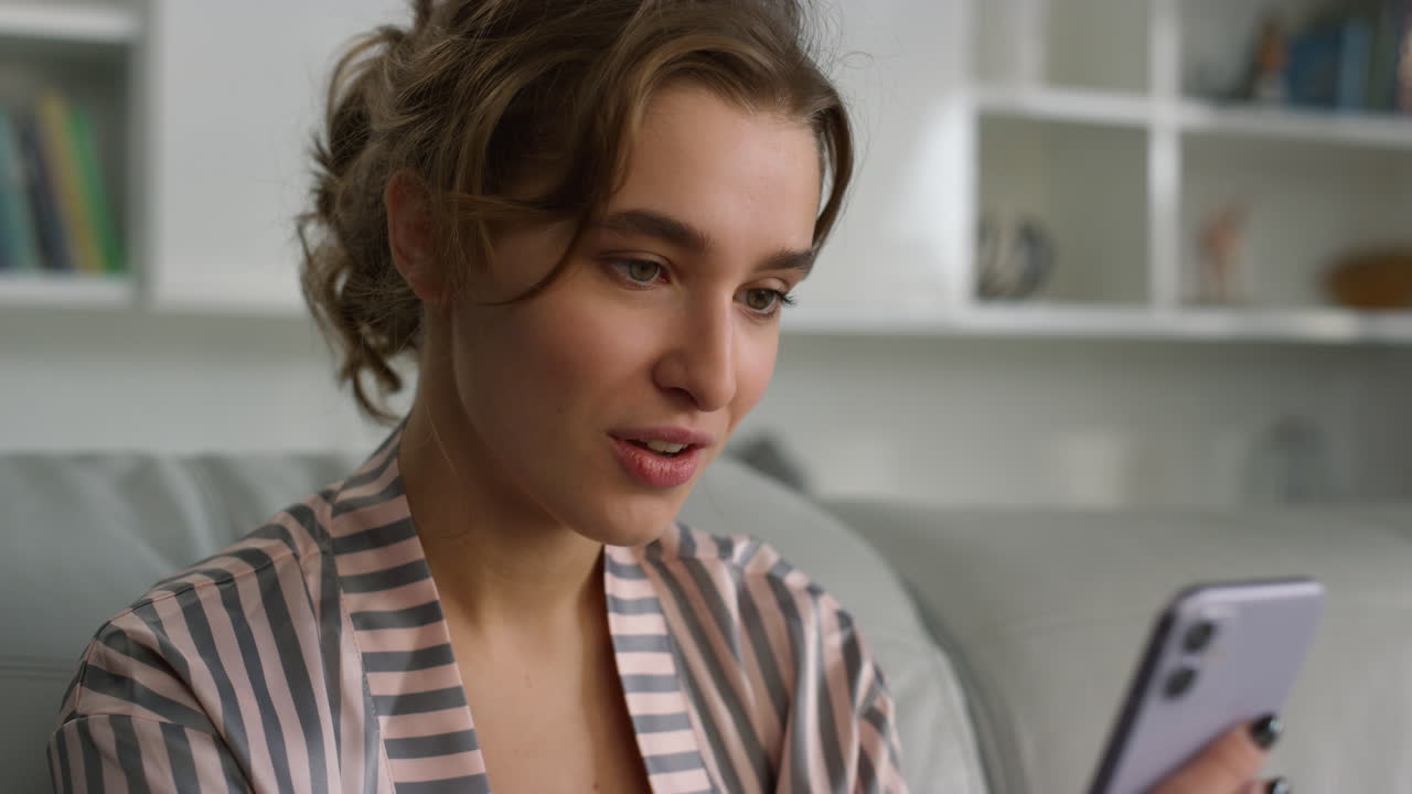 App customer holding smartphone at home closeup. Surprised girl checking account
