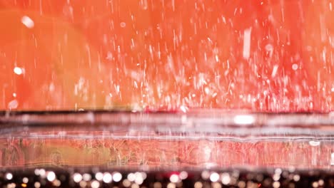 glass of cola. ice cola with splashing bubbles slow motion on a blurry light ,blurry background.