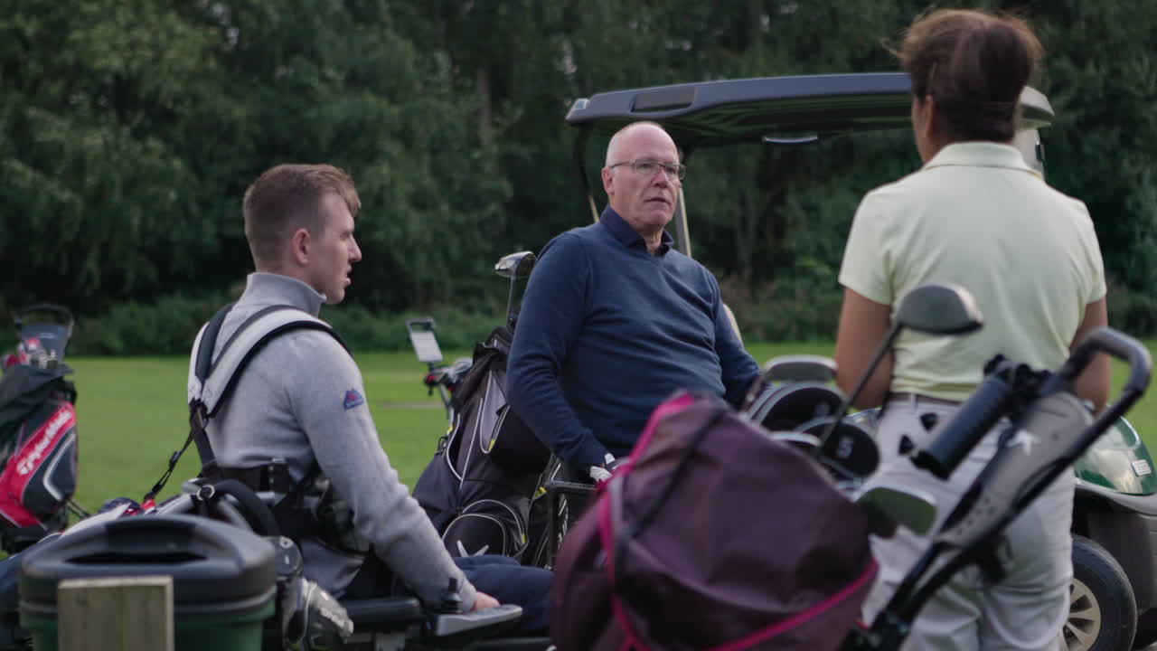 Men on a golf course near a golf cart