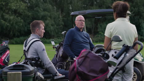 men on a golf course near a golf cart