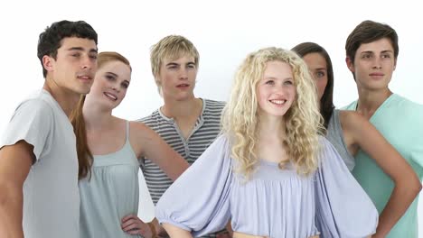 group of teenagers standing in front of the camera