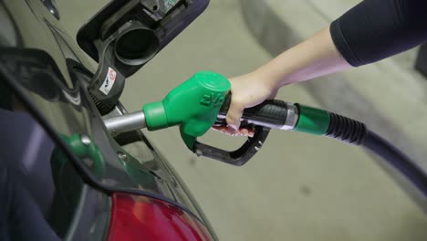 person refueling car on a gas station