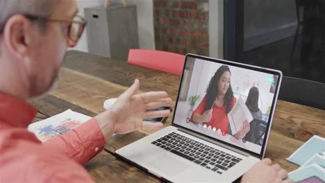 Caucasian-businessman-on-laptop-video-call-with-caucasian-female-colleague-on-screen