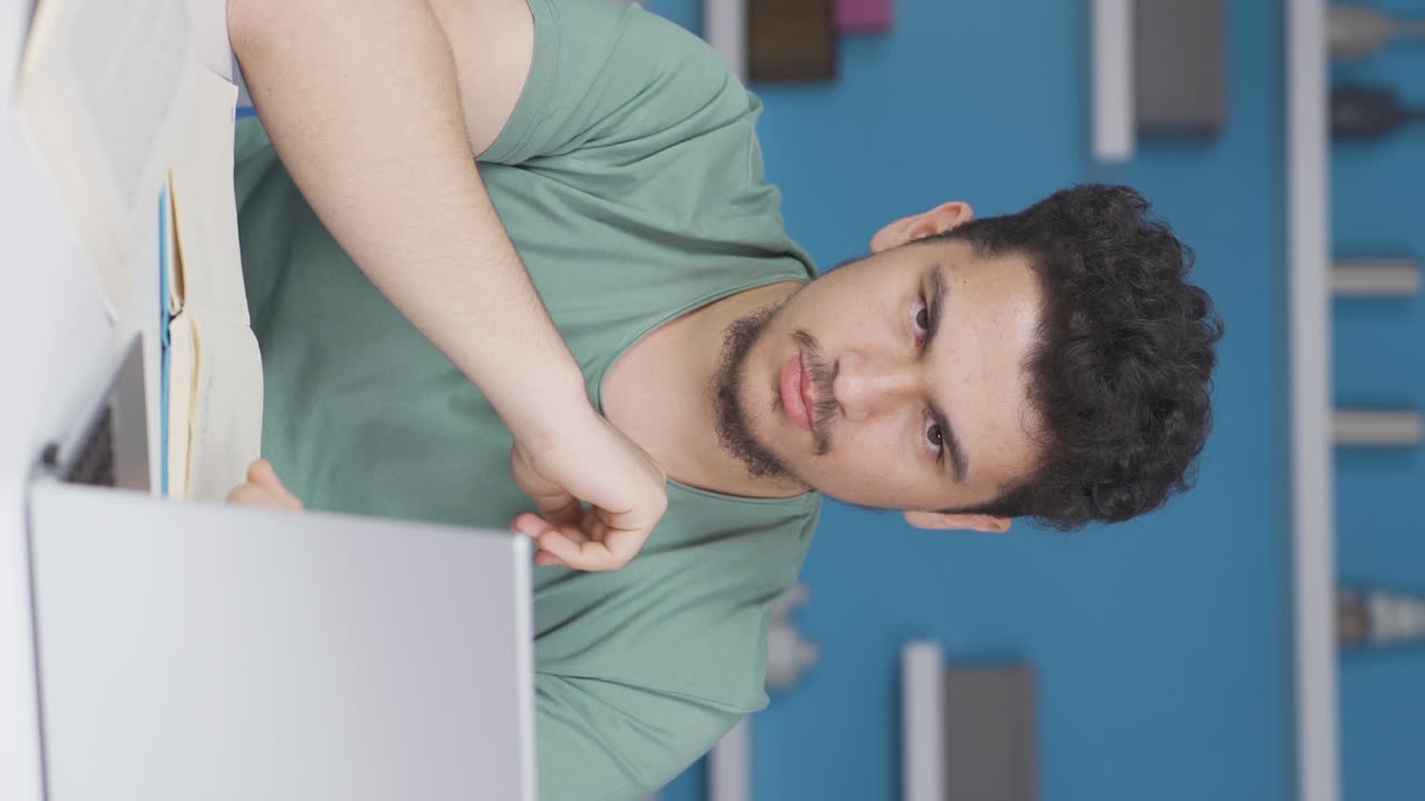 video vertical de un estudiante masculino mirando a la cámara con un gesto negativo y negativo.