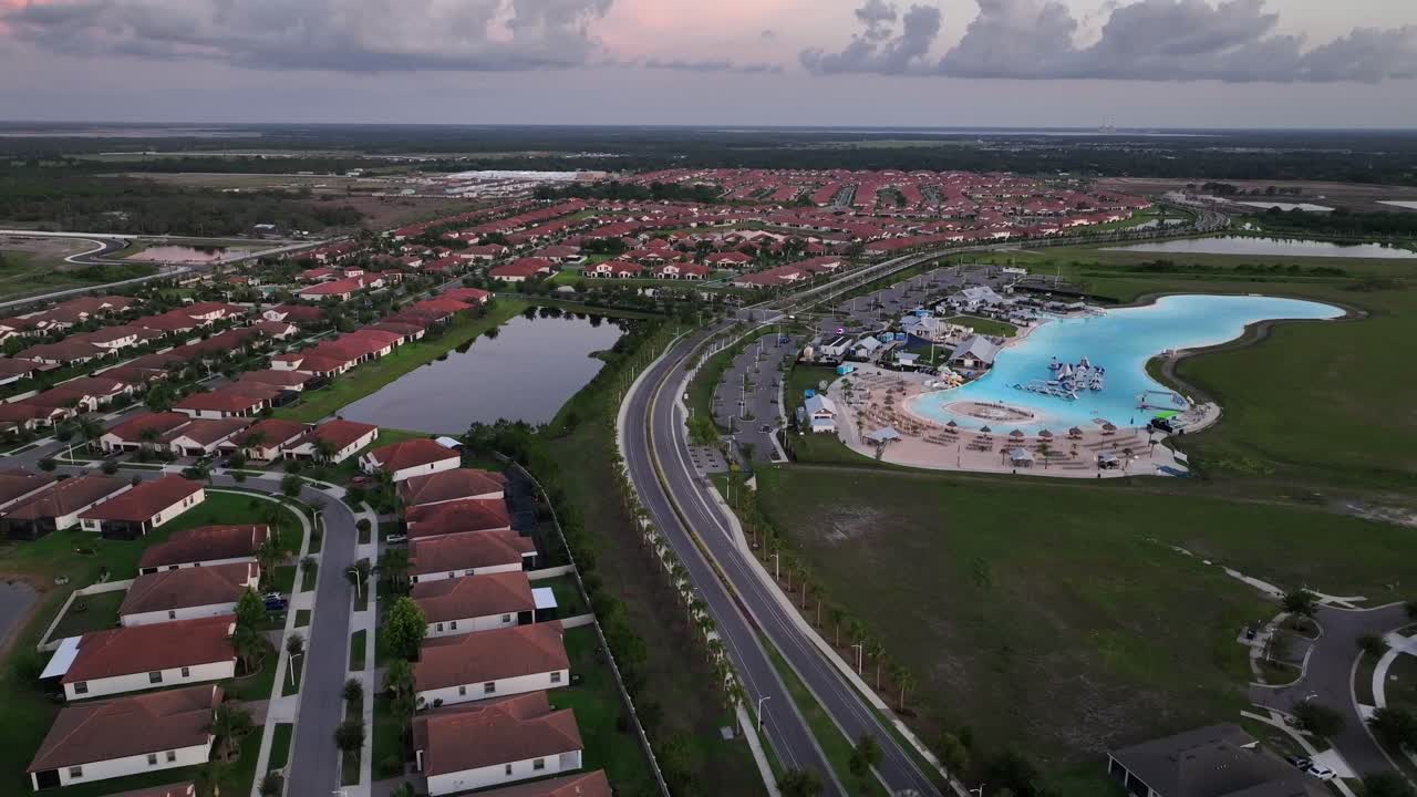 Southshore Bay Lagoon In suburb of sun city with luxury mansions in neighborhood. Aerial wide shot. Turquoise water at waterpark of Florida, USA. Sunny day in summer