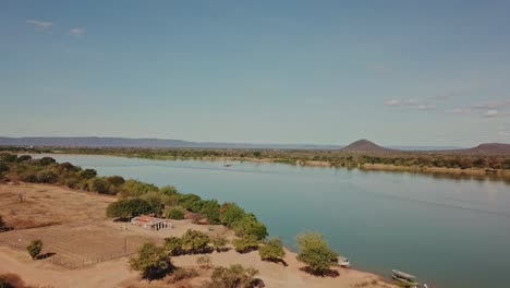 dry, arid fields surround the sao francisco river during a drought caused by climate change