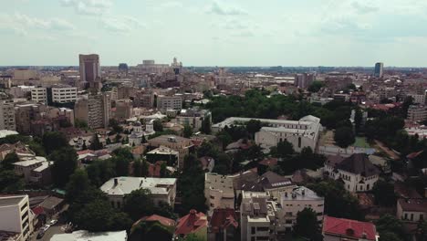 Flying-forward-drone-shot-of-the-Bucharest-skyline-on-a-hot-summer-day