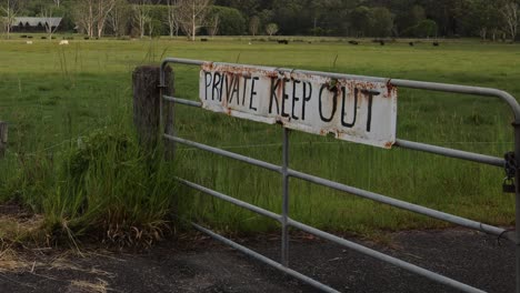 gate with 'private keep out' sign over time