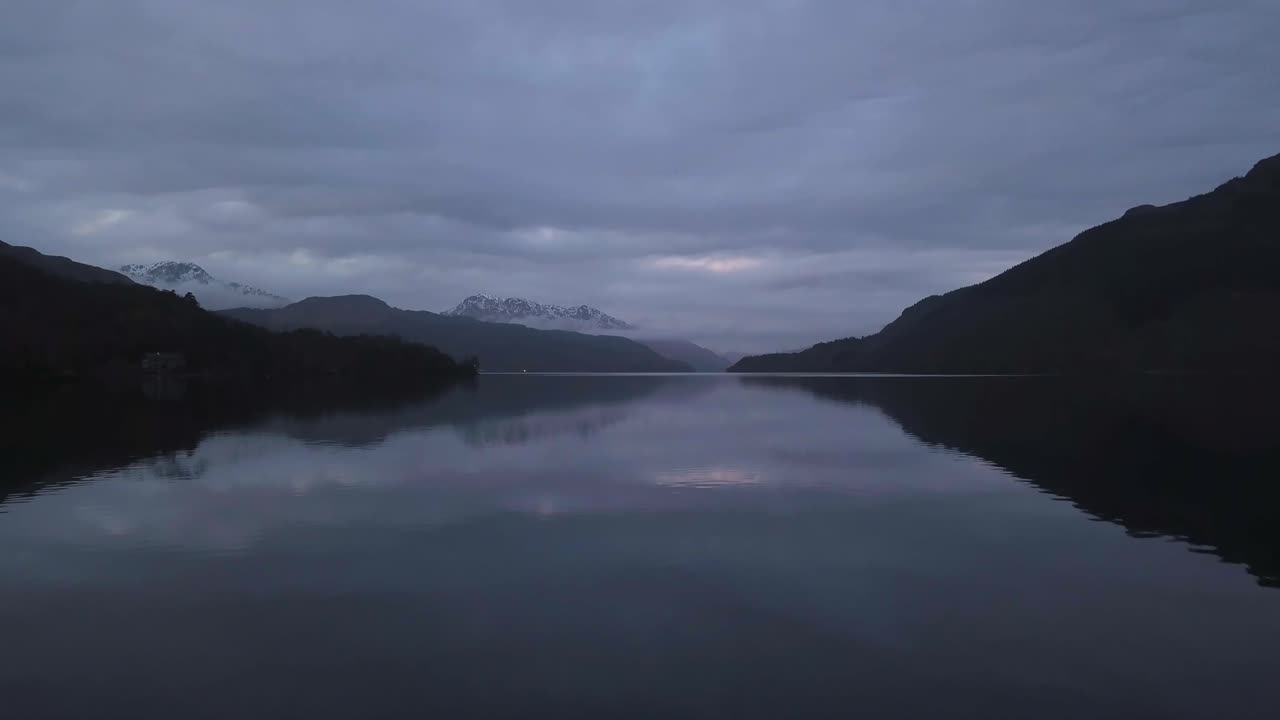 A low flight reveal over a lake in Scotland during the winter