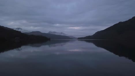 a low flight reveal over a lake in scotland during the winter