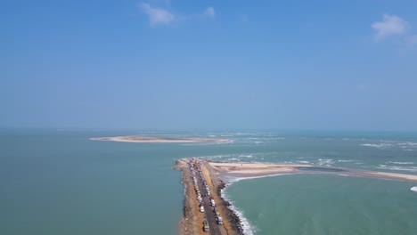 aerial drone shot of dhanushkodi, showcasing the iconic last road of india stretching into the horizon.