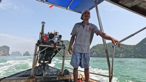 man steering a boat through scenic islands