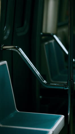 blue seats and handrail on a subway car