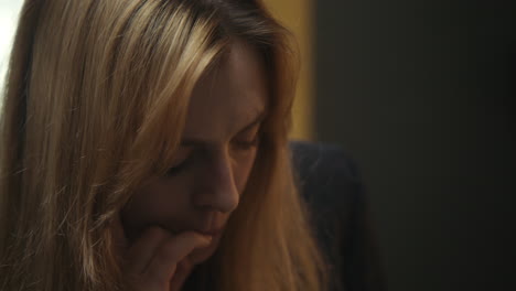 close-up of a woman looking pensive