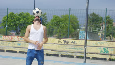 handsome man practicing soccer tricks