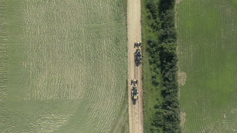 Two-Road-levelling-tractor-grader-at-work-on-rural-road-of-Saskatchewan,-Canada,-top-down