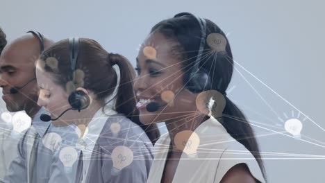 Animation-of-network-of-connection-with-icons-over-business-people-wearing-phone-headsets