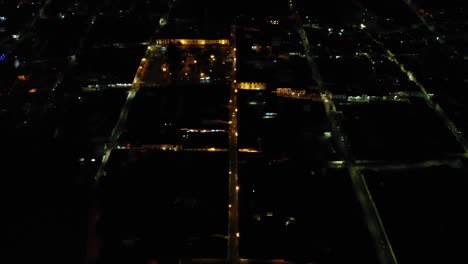 City-streets-and-their-bright-lights-seen-from-above,-aerial,-Salento,-Colombia