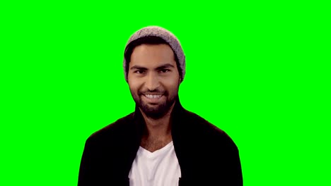 smiling man standing against green screen