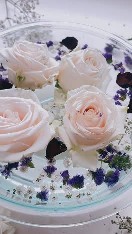 delicate floating roses in a glass bowl