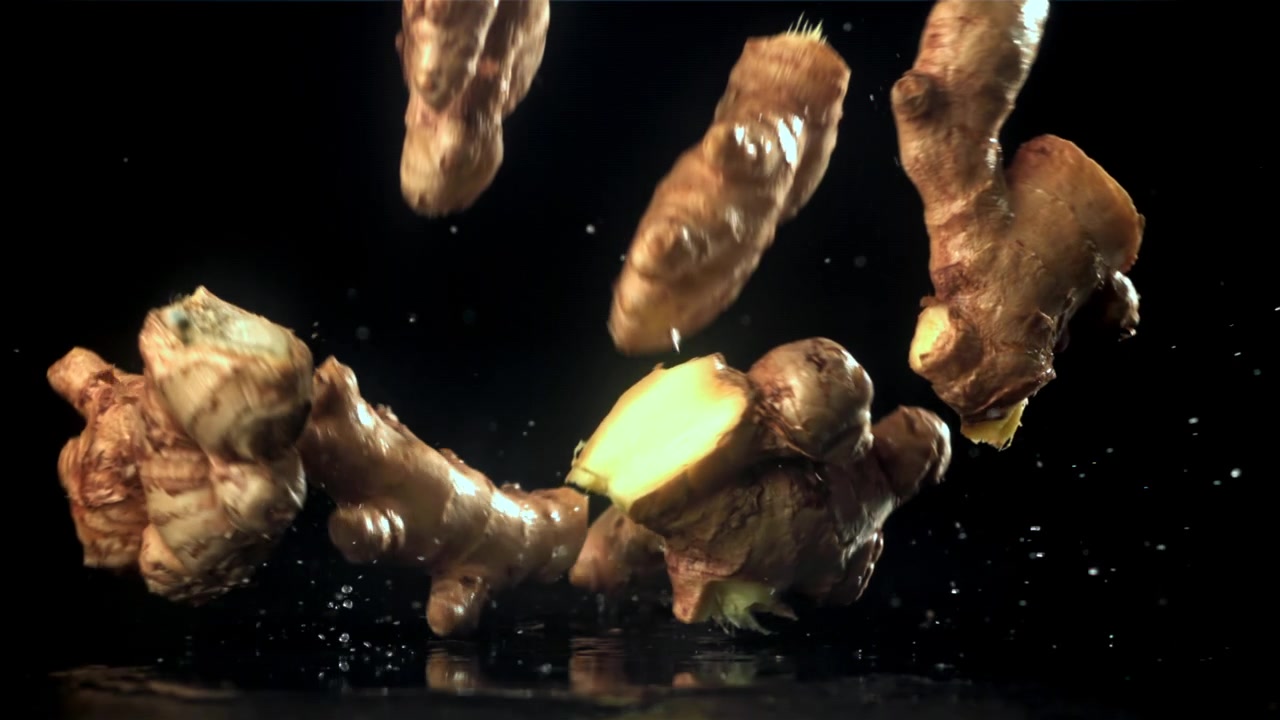 Fresh Ginger Root Falling and Splashing in Slow Motion