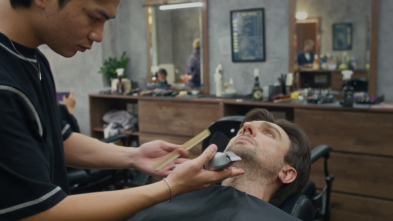 Barber gives a haircut to a client in a barbershop
