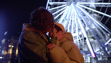 tender couple kissing at night city