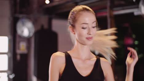 Slow-Motion-Of-Beautiful-Female-Athlete-Tying-Hair-Before-Workout-At-Health-Club