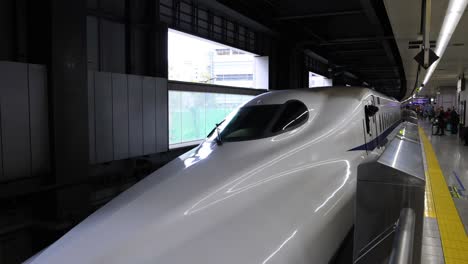 bullet train pulls into and leaves the station