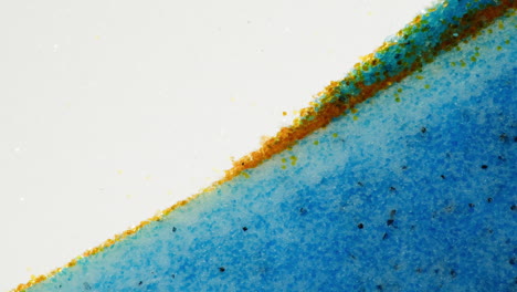 close-up of mixed blue and orange granular material