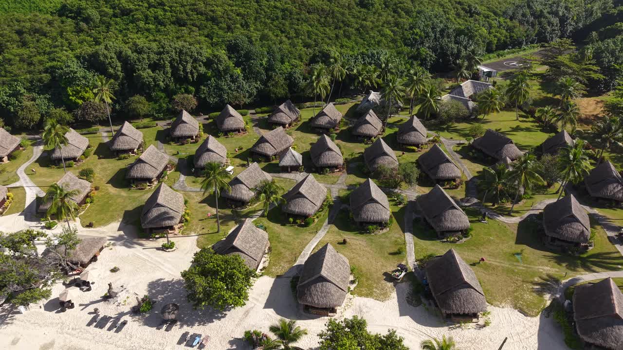 Moorea Island, French Polynesia, Aerial View of Traditional Beachfront Villas, Resort in Tropical Lush, Revealing Drone Shot
