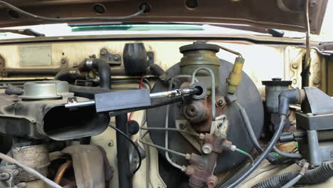 close up view of checking going on spark plugs in car engine of a toyota pick up truck in an auto service station