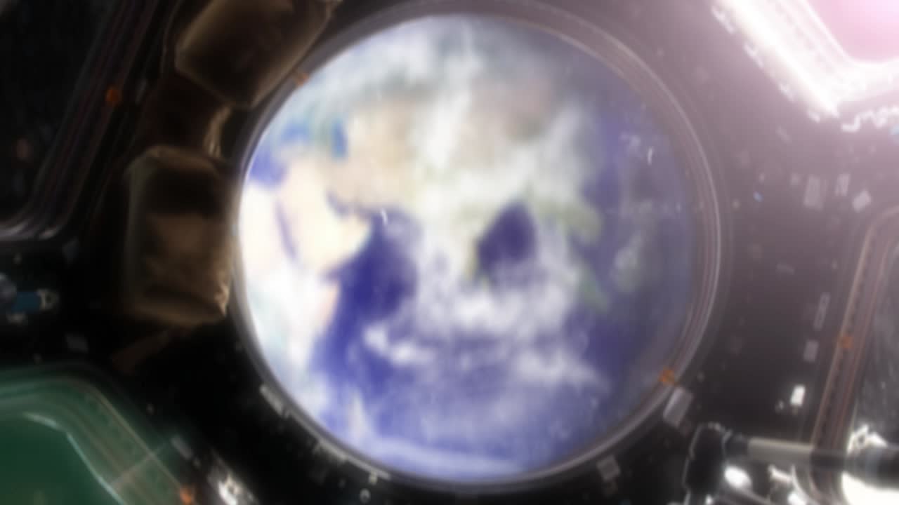 Incredible view of Earth from the international space station (ISS). Camera floats backwards and focus pulls onto the observation deck of the ISS. We see Earth from inside and outside the station. 3D