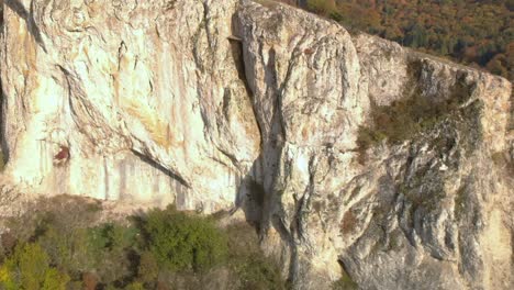 high aerial footage of birds flight away from rock