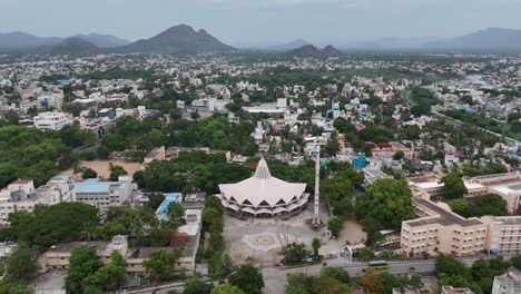 aerial drone shot of a church in vellore city, a morning view of the highway with light fog, creating a soft and ethereal ambiance over the landscape.