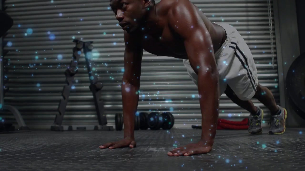 Vertical video: Lowering from plank, shirtless trainee doing pushups on garage mat blue speck