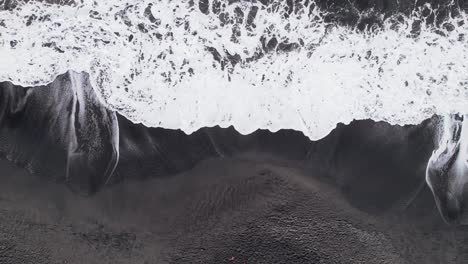 Black-Sand-Beach-With-Foamy-Waves-Splashing-In-Grand-Anse-Beach,-Guadeloupe,-France---Aerial-Top-Down