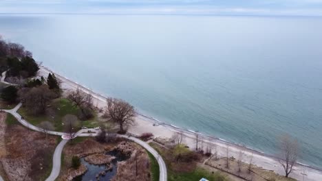 drone orbiting lakeside path in ajax neighborhood in spring