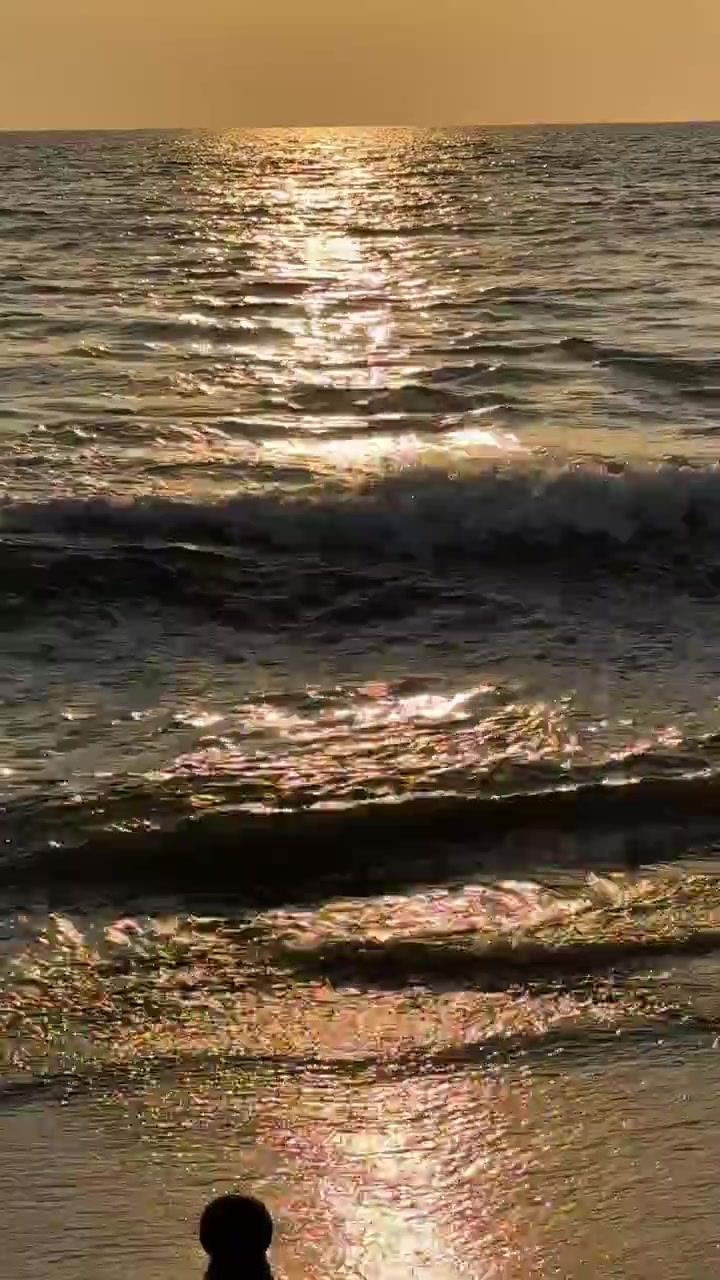 Shimmering Golden Sunset Reflected on Calm Sea Waves