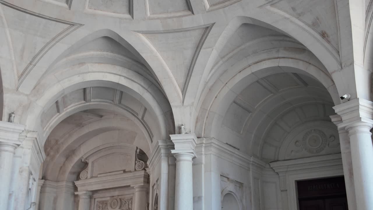 Elegant arches supporting dome ceiling inside Palace of Ajuda, Lisbon, Portugal, showing architectural detail and symmetry. Panning shot