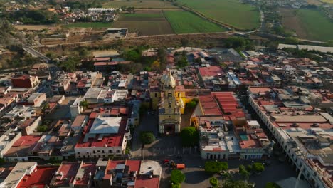 Aerial-dolly-in,-tilt-down-of-Santuario-Diosesano-church-in-rural-Tamazula,-Mexico