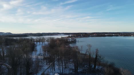 Aerial-sunset-flight-over-lake-Chiemsee-in-winter-time