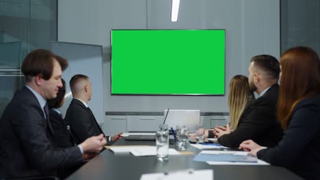 green screen in office at teleconference with business partners