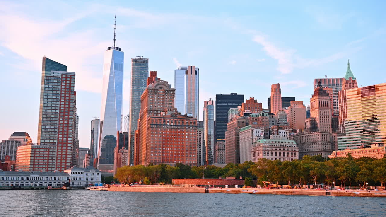 Moving on boat along the green waterfront of New York, USA. Beautiful high-rise skyline of metropolis at backdrop