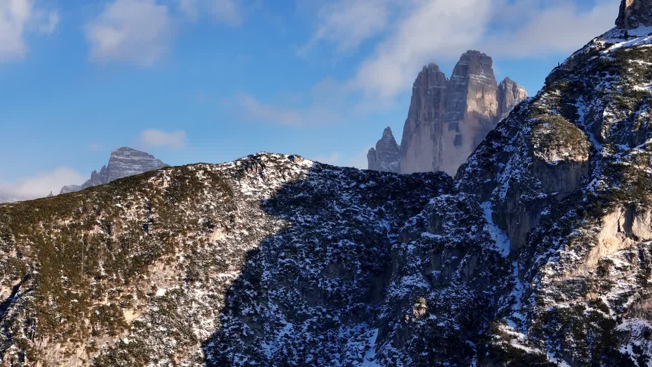 Reveal shot of The Drei Zinnen in the Italian Dolomites during winter season (drone footage)