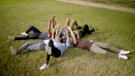 smiling young people using smartphones.